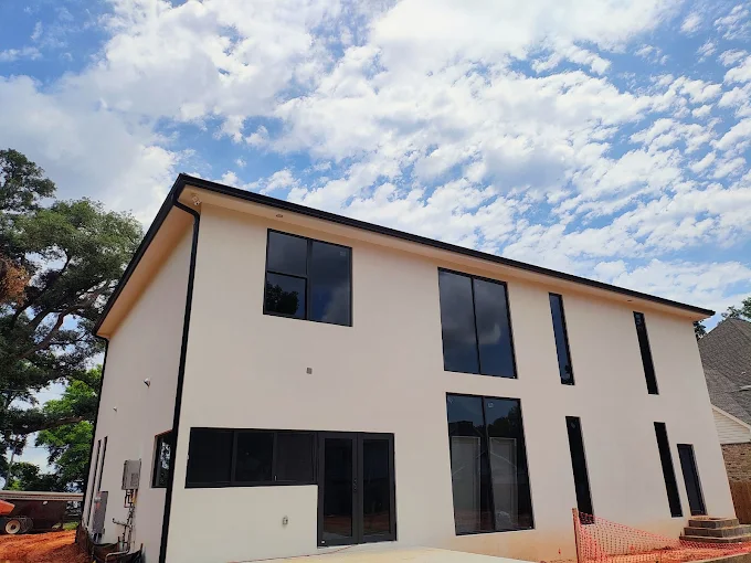 Black gutter system installed on a modern two-story home exterior.