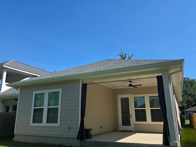 Finished gutter and downspout system on a covered backyard patio.